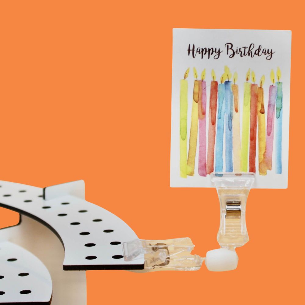 Close up of Candelabra Clip holding a birthday card as decoration